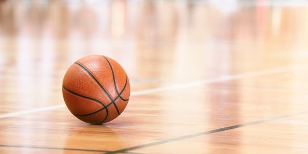 Photo of basketball on gym floor