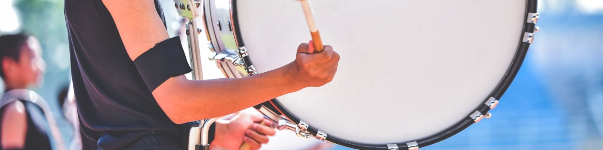 student hitting a drum