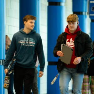 Two students walking down the hall